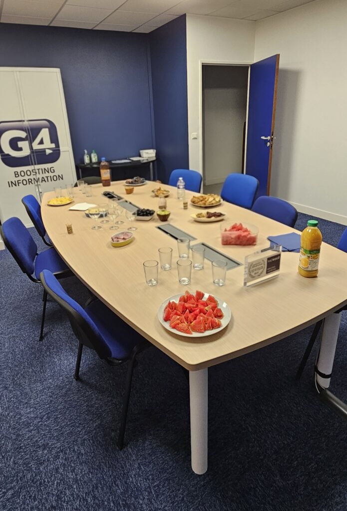 salle de réunion dans laquelle figure une table remplie de denrées alimentaires dont des spécialités portugaises.